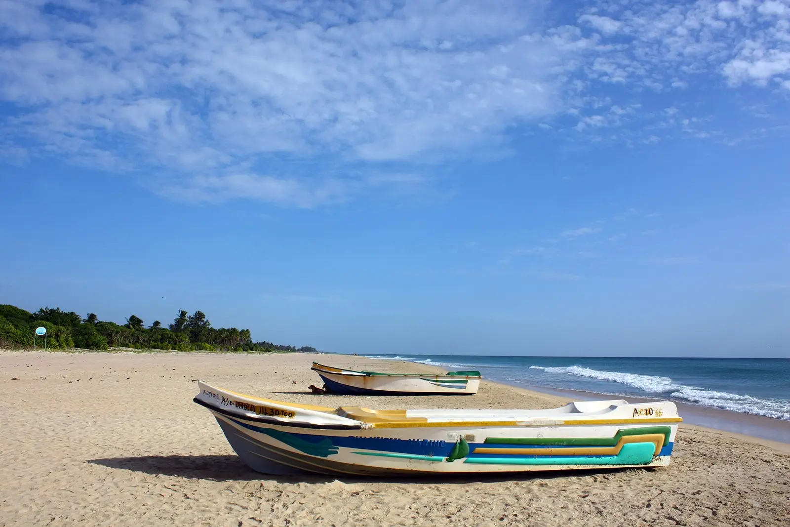 Fishing boat on a white sand beach near Trincomalee